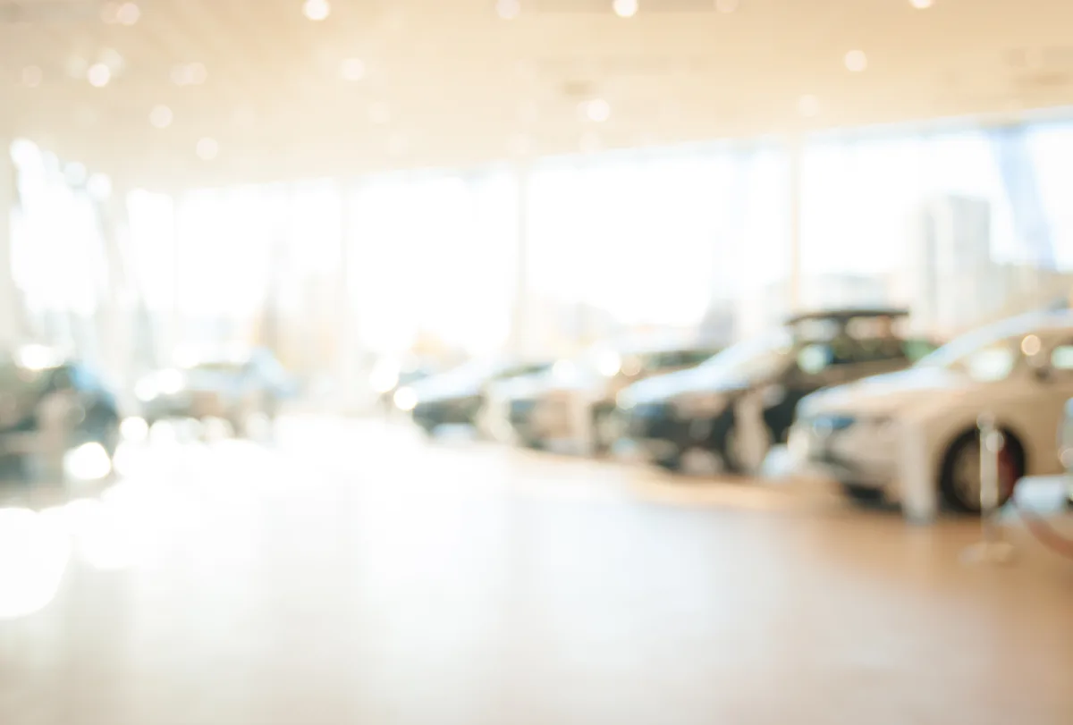 Premium automotive dealership showroom with vehicles on display under modern lighting