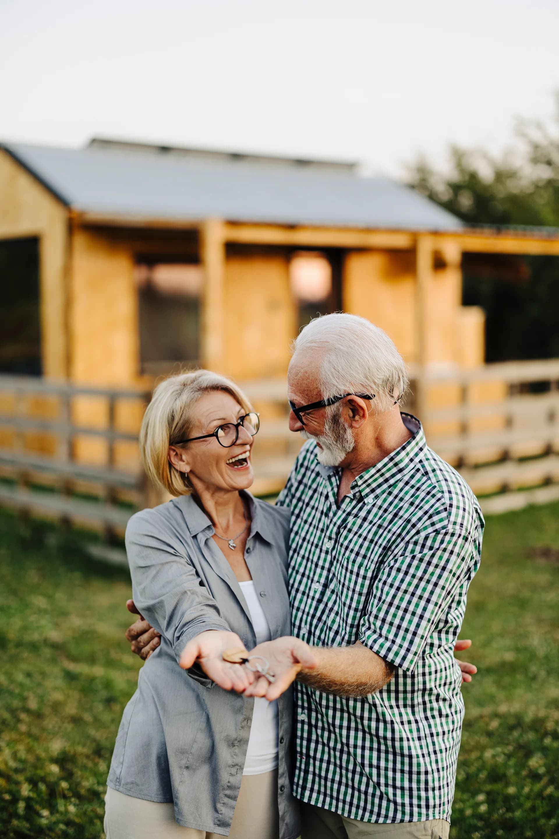 A long-time member couple holding the keys to their refinanced home